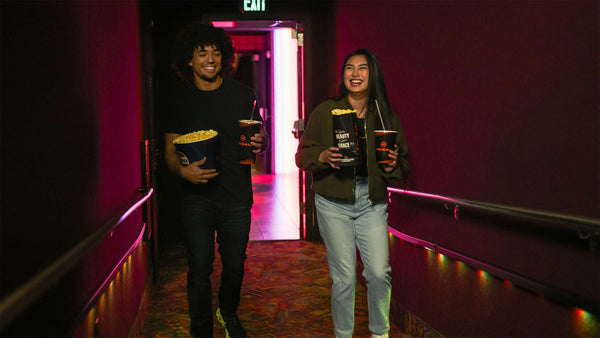 couple with popcorn at the movies