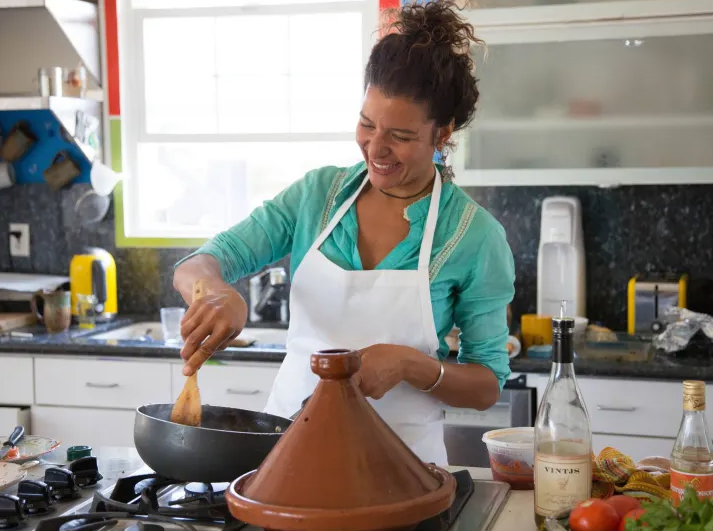 Woman cooking in cooking class.png