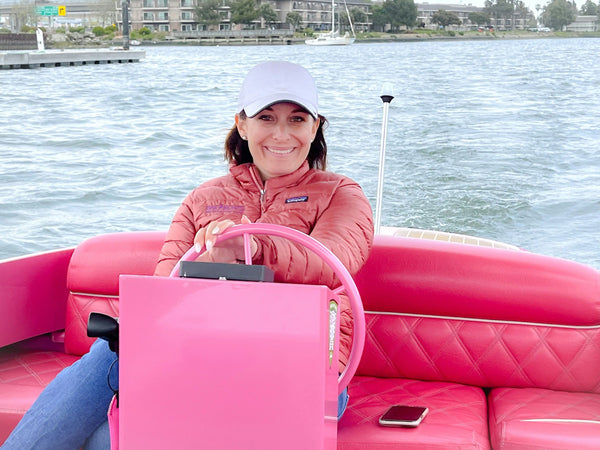 woman driving pink boat.jpg