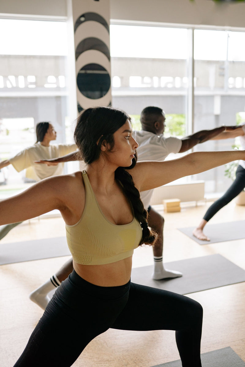 woman-in-beige-with-braid-doing-yoga