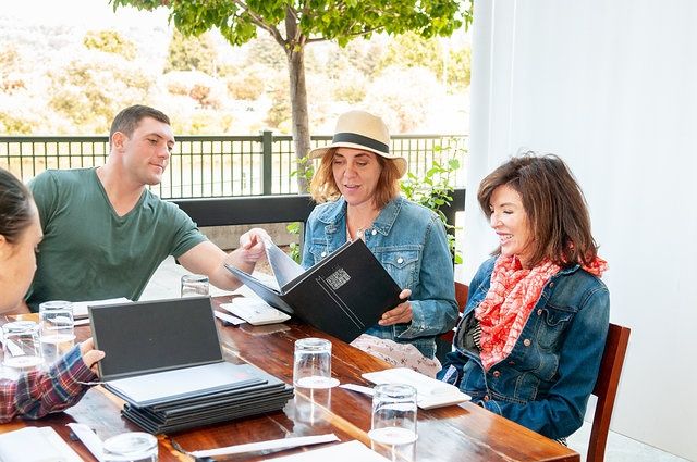 woman-in-jean-jack-with-woman-in-hat-and-man-in-green-shirt