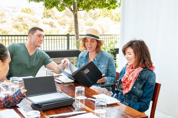 woman-in-jean-jack-with-woman-in-hat-and-man-in-green-shirt