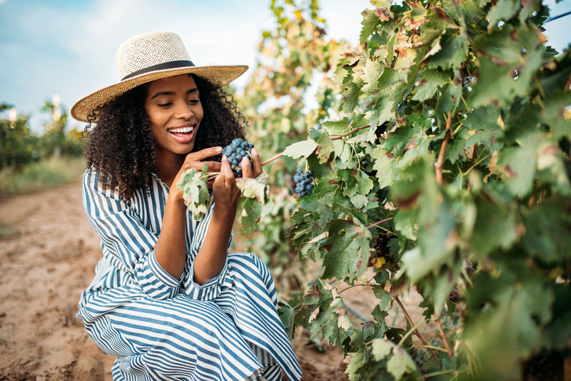 woman looking at grapes