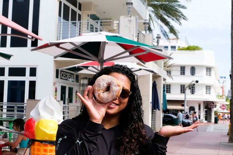 woman looking through donut