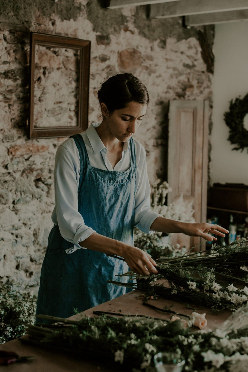 woman making a floral arrangement