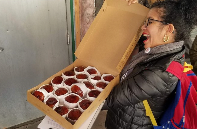 woman presenting donuts