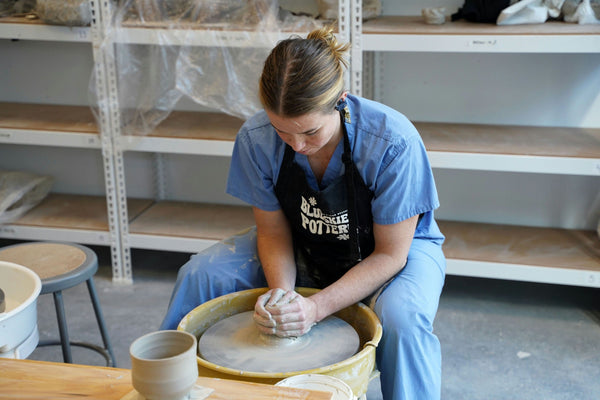 Woman using pottery wheel