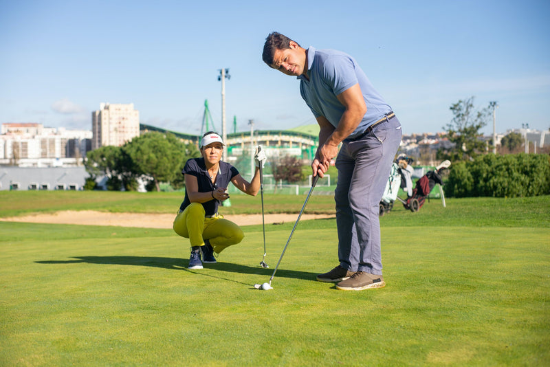 woman-watching-man-putt