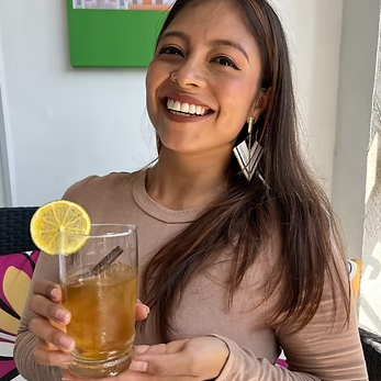 Woman with drink from drink making kit.png