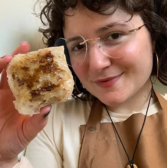 Dumplings on plate with sauce.png