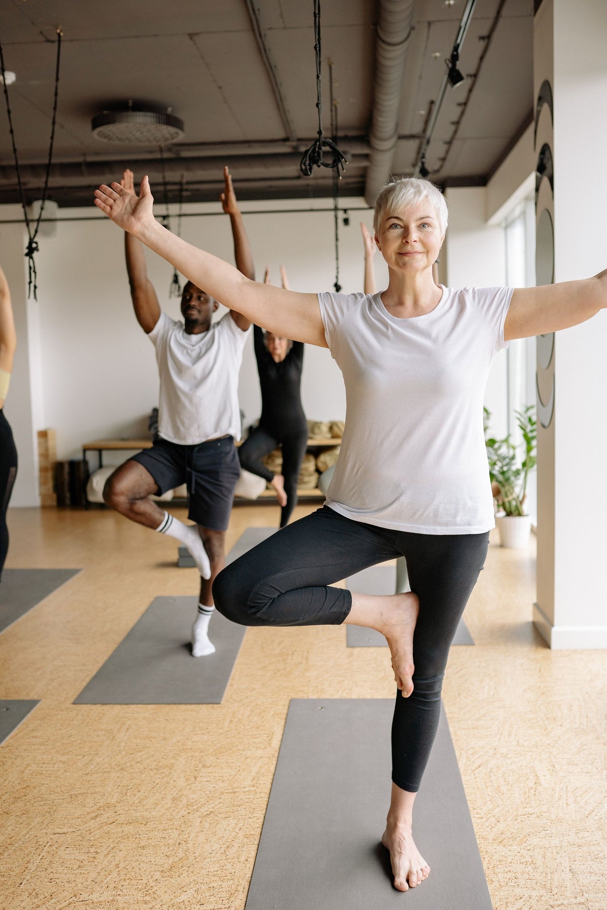 woman-with-grey-hair-smiling-in-a-yoga-class