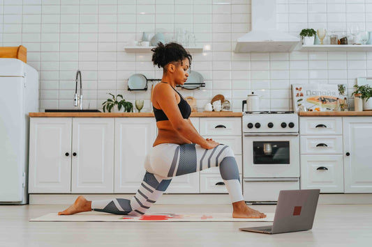 woman doing virtual yoga in her kitchen
