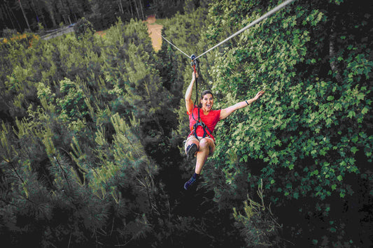woman in red loving her zip line time