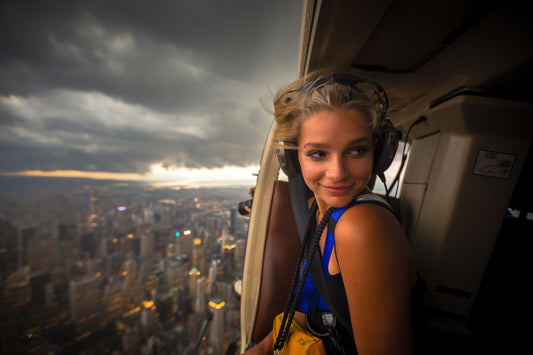 woman looking out helicopter over new york