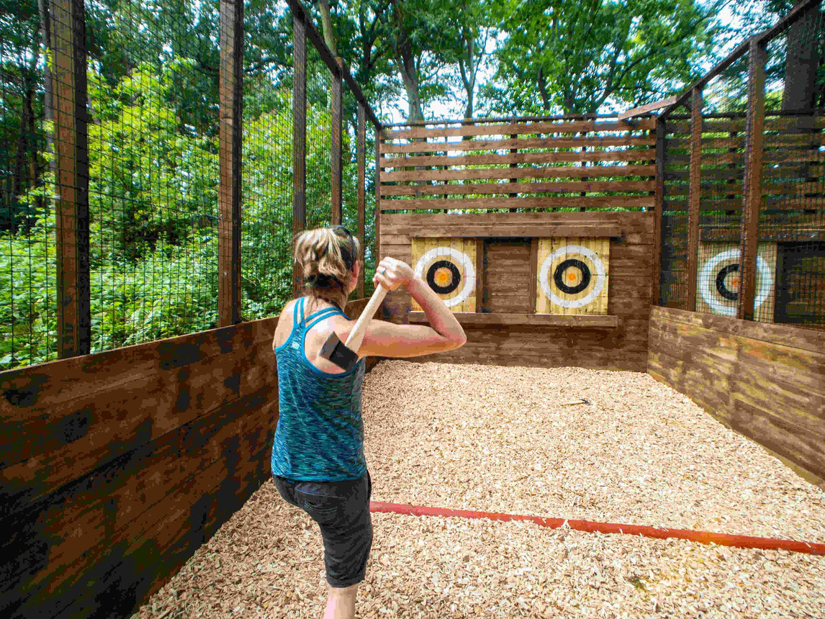 women-in-green-shirt-about-to-throw-an-axe