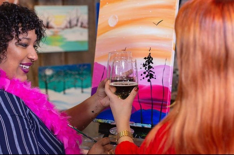 women-saying-cheers-while-painting