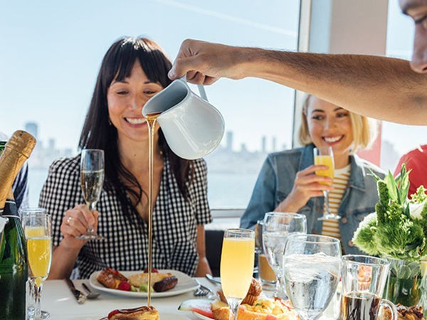 women smiling while pouring syrup