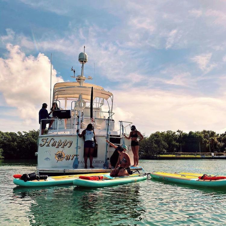 yacht with paddle boards