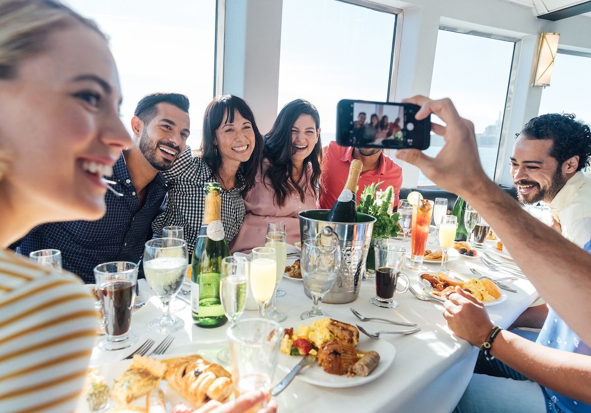young-adults-taking-a-photo-on-a-brunch-cruise