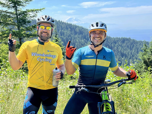 2 men in helmets with bikes