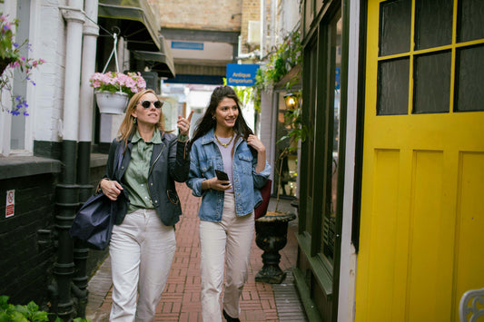 Girls in shopping center walking next to yellow door