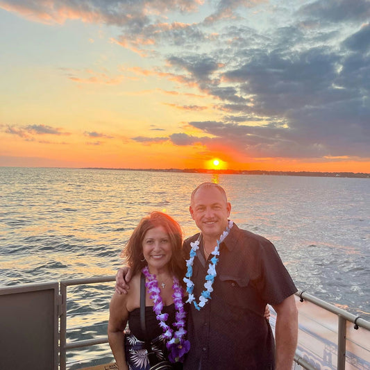 couple with sunset on tiki boat