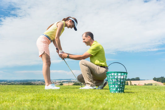 man and woman learning golf