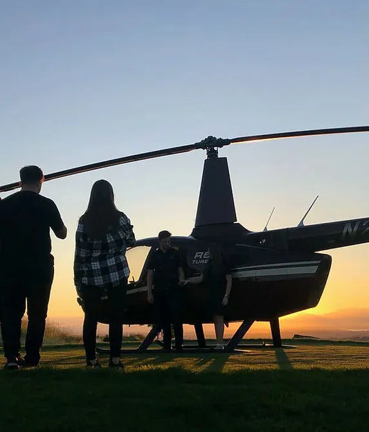 people with helicopter at sunset