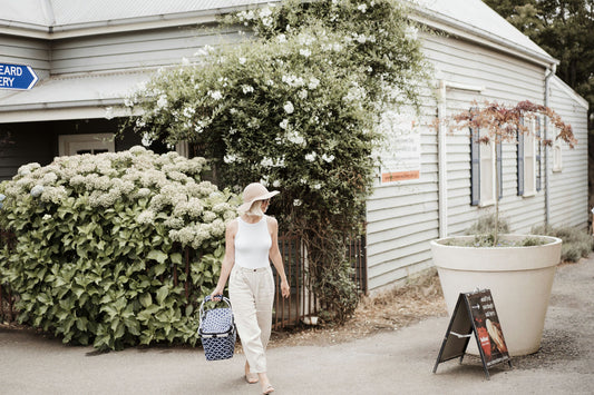 woman in white shirt walking with picnic basket